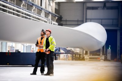 Vestas employees perform final checks on a newly completed, 115.5 meter long, 15 megawatt V236 wind turbine blade at their factory in Nakskov, Denmark.