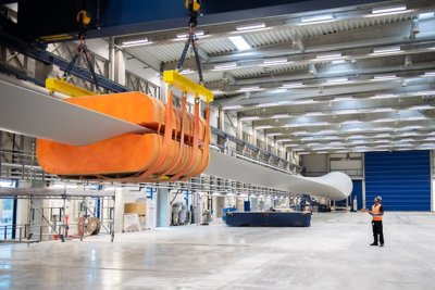 Vestas employees perform final checks on a newly completed 15 megawatt V236 wind turbine blade at their factory in Nakskov, Denmark.